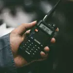 walkie talkie in hand
