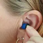 woman putting ear piece in